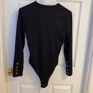 Black bodysuit detailed with gold buttons